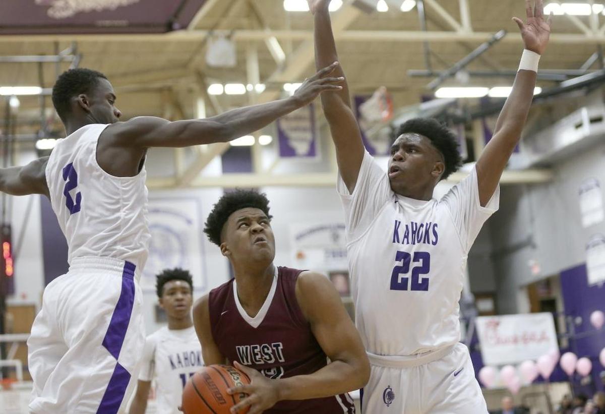 Belleville West's Keith Randolph works to get a shot off against Collinsville's Kenrique Brown and Austin Knight last year.