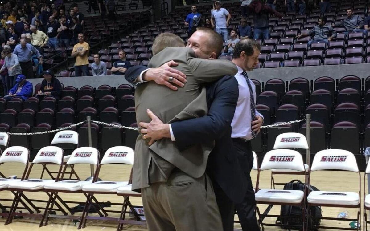 Central coach Jeremy Shubert hugs assistant coach Donny Petterson on Tuesday following Cougars’ super-sectional win over Teutopolis