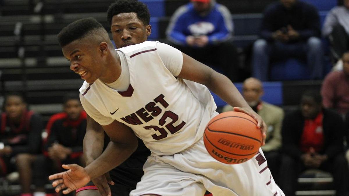 Belleville West's EJ Liddell drives the ball past McCluer's Ryan Warren-Hogue during their game at the Chick-fil-A Green Mount Commons Classic at Belleville East on Wednesday.