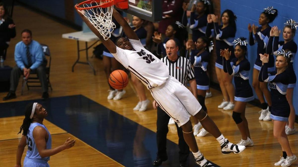 Belleville West's Eric Liddell dunks the ball as Belleville East's E.J. Alridge look on during their Class 4A Regional last year.