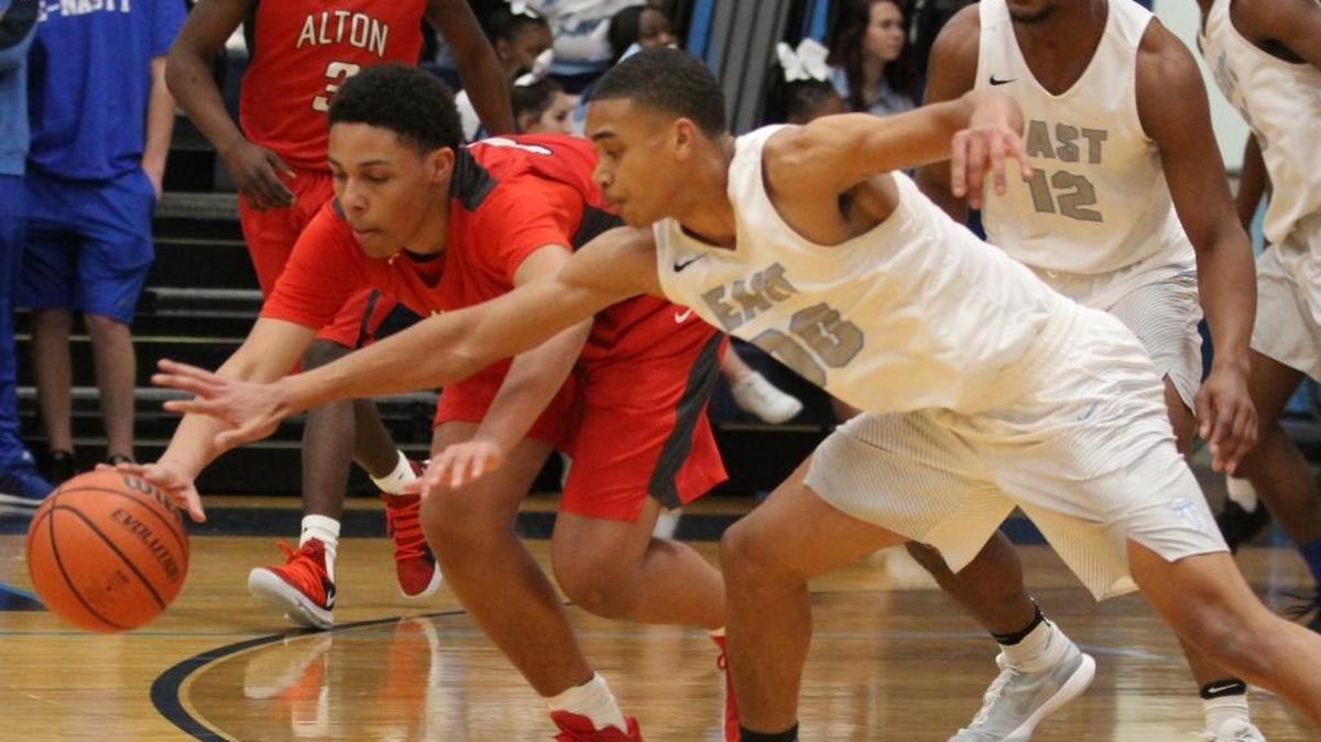 Alton’s Josh Rivers and Belleville East’s Jaylen Lacey battle for a loose ball in a Southwestern Conference game Friday night.