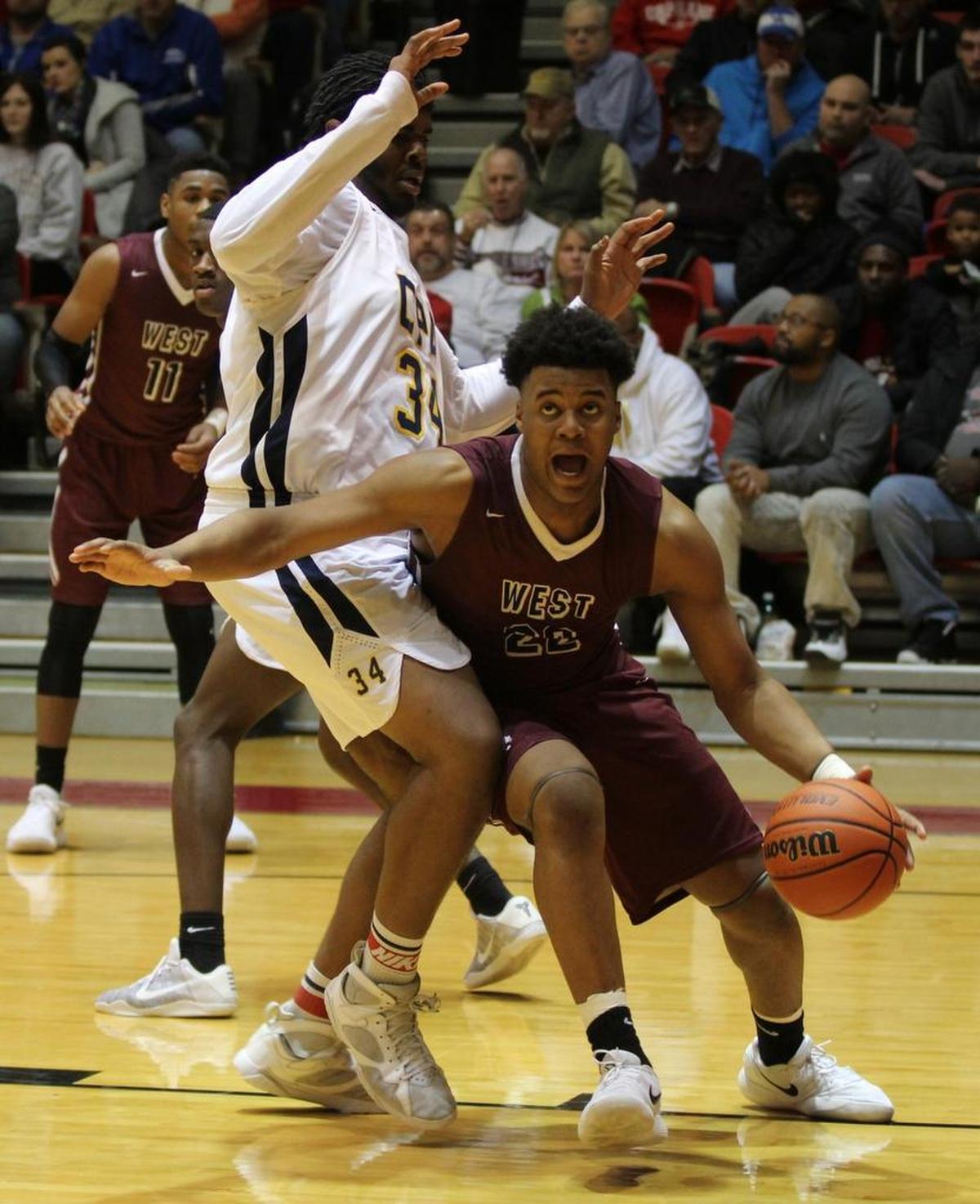 Belleville West junior Keith Randolph looks for a shot under the basket and around Confluence Academy’s senior Ahmad Hodges in the quarterfinals of the Centralia Holiday Tournament in 2017.