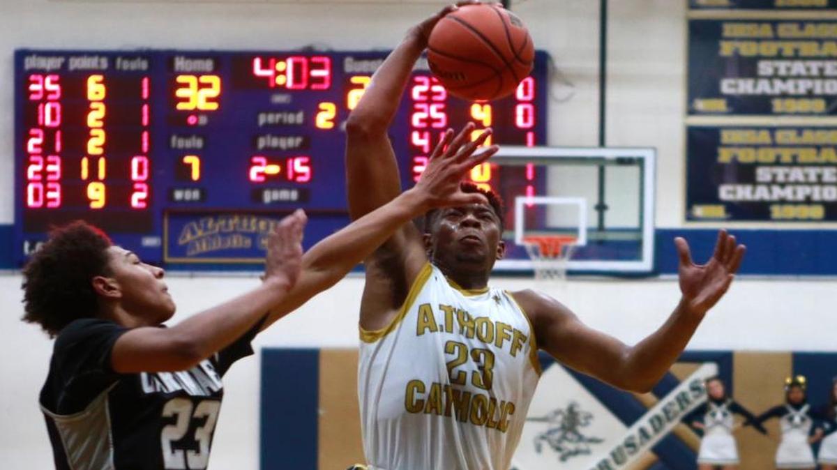 Althoff’s Jordan Goodwin drives to the hoop past Cabondale’s James Baltz during their high school boys basketball game Friday at Althoff. The Crusaders scored an easy win over Carbondale in the South Seven Conference game. See a gallery of photographs at bnd.com.