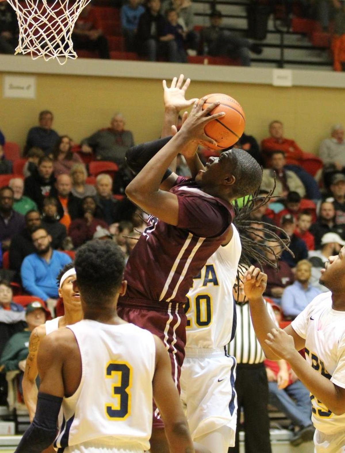 Belleville West junior EJ Liddell goes up for two of his game-high 26 points against Confluence Academy in the quarterfinals of the Centralia Holiday Tournament Friday.