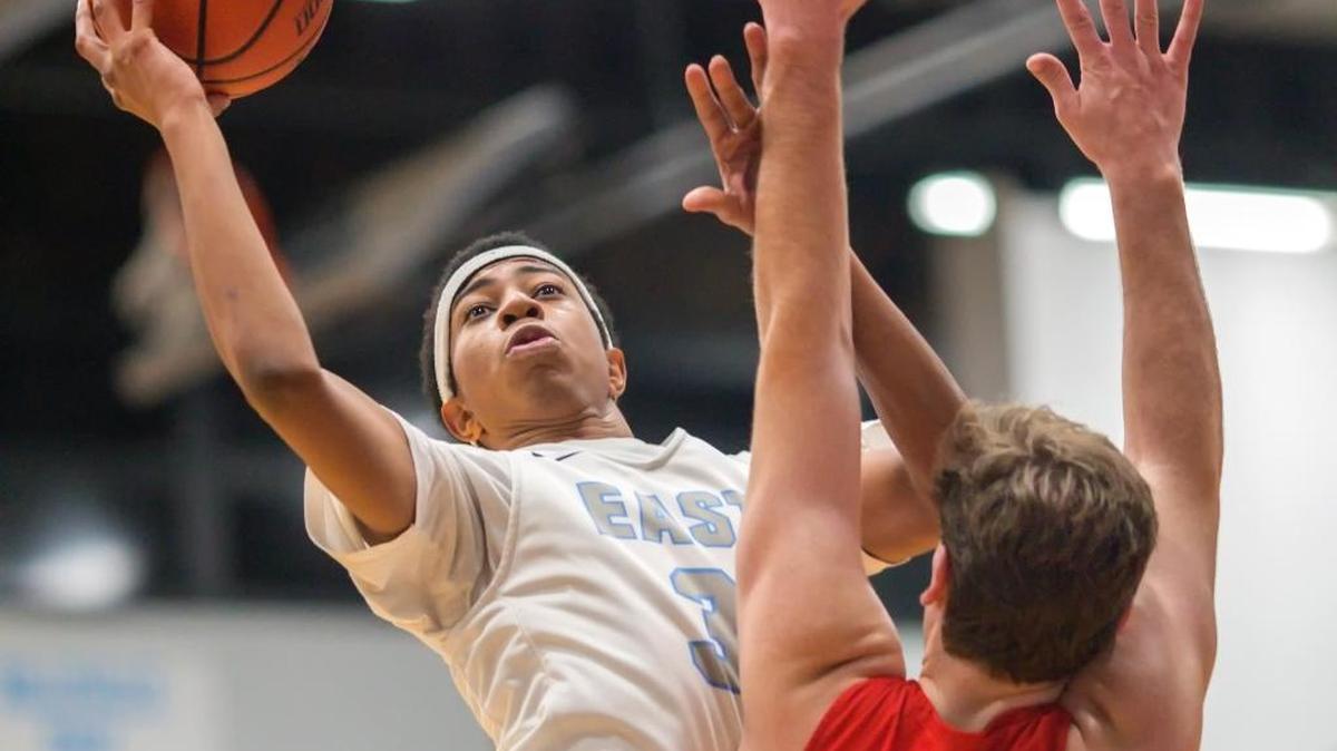 Belleville East’s Isaiah May drives to the basket against Chaminade’s Henry Gladson during Wednesday’s Chick-fil-A Classic basketball tournament at Belleville East High School.