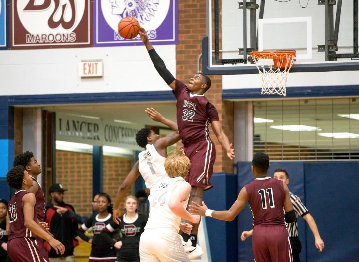 Belleville West’s EJ Liddell (32) goes up high to block a shot by Belleville East’s Riley Barnes (1) during Friday’s Southwestern Conference game at Belleville East High School.