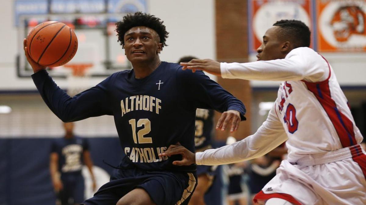 Althoff’s C. J. Coldon feels pressure from McCluer’s Anthony Harris during their game at at Belleville East on Friday.
