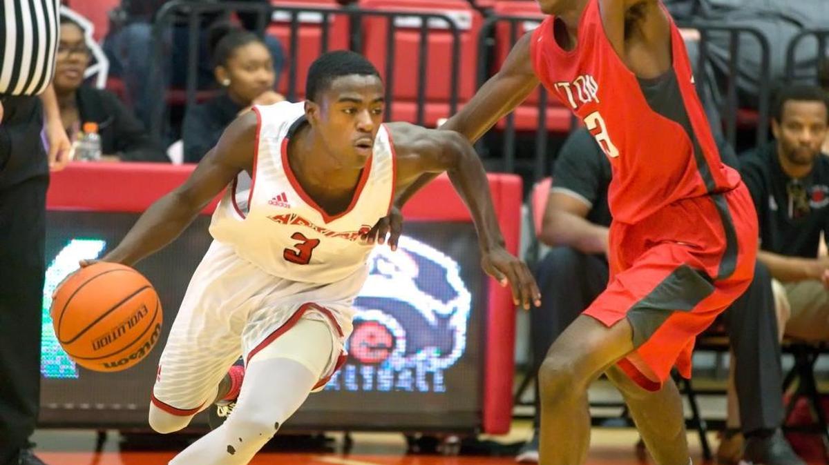 Granite City’s Justin Wiley tries to work the ball past Alton defender Charles Miller during the teams’ Southwestern Conference opener at SIUE Saturday.
