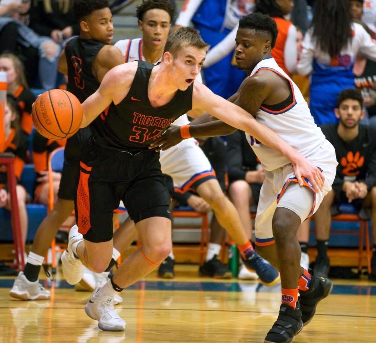 Edwardsville’s Caleb Strohmeier brings the ball up the court against the East St. Louis Flyers during Wednesday’s Southwestern Conference game at East St. Louis Senior High School.