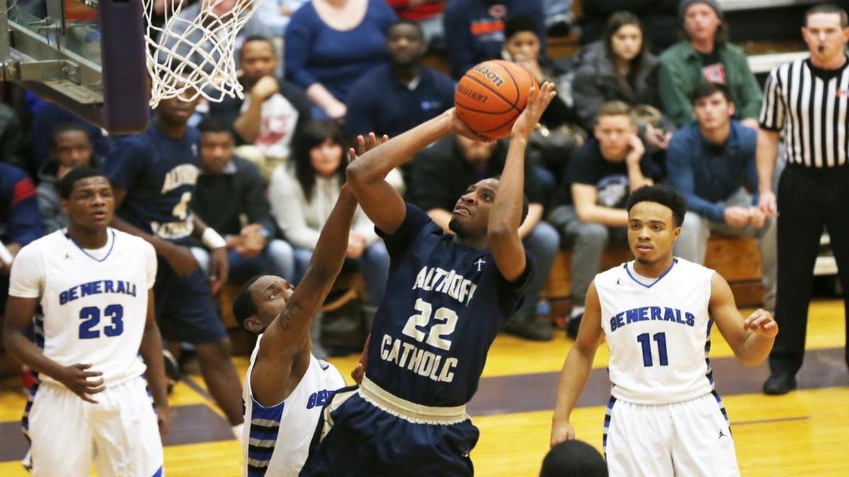 Althoff's Brendon Gooch shoots past MacArthur’s D.J. Smith during their championship game at the Collinsville-Prairie Farms Holiday Classic.