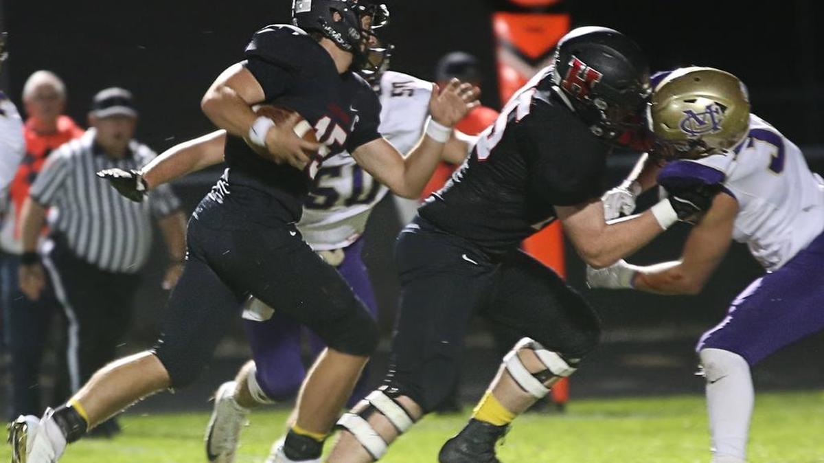 Highland quarterback Jack Etter gets a block and some extra yards in a dominating Bulldogs win over Civic Memorial Friday.