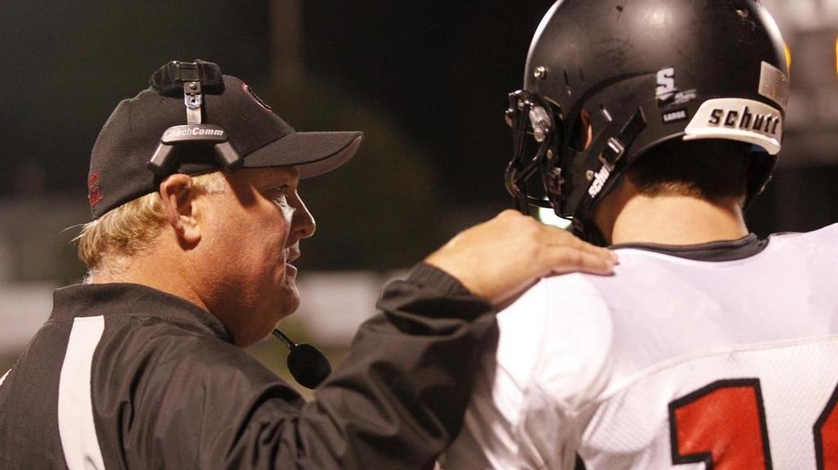 Granite City head coach Carl Luehmann talsk to his QB during their game against West in 2014.