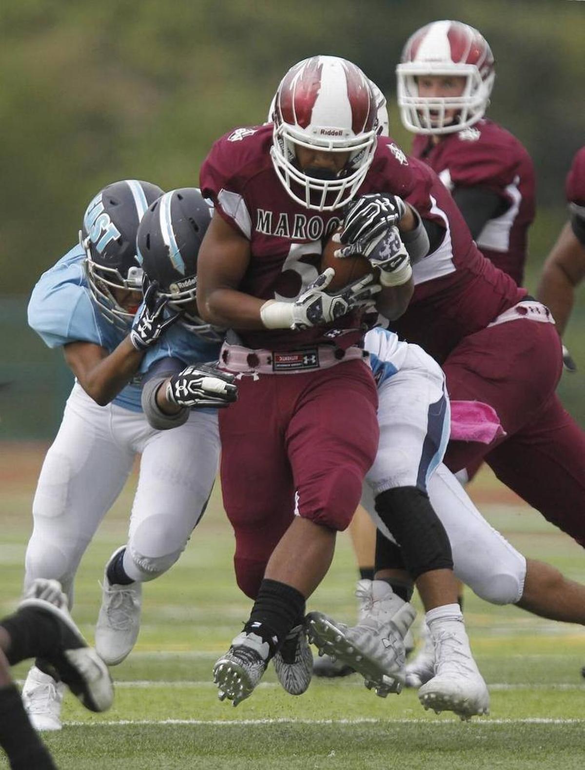 Belleville West running back Kriston Davis pushes forward for yardage during a game against Belleville East in 2016.