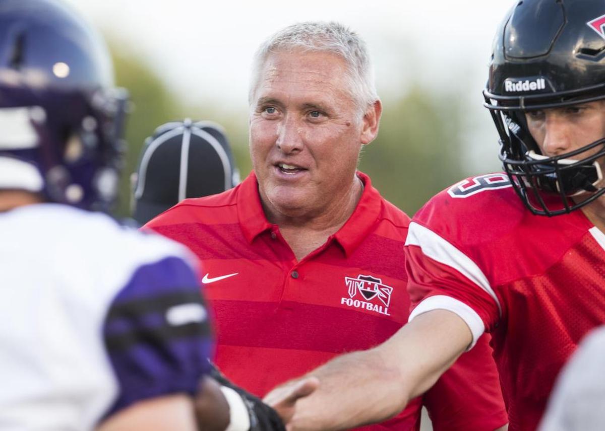 Triad football coach Paul Bassler is pictured during the coin toss before a game against Collinsville in 2018. Bassler resigned as the Knights coach in November and Calvin Potthast was hired Monday, Jan. 9, as his replacement.