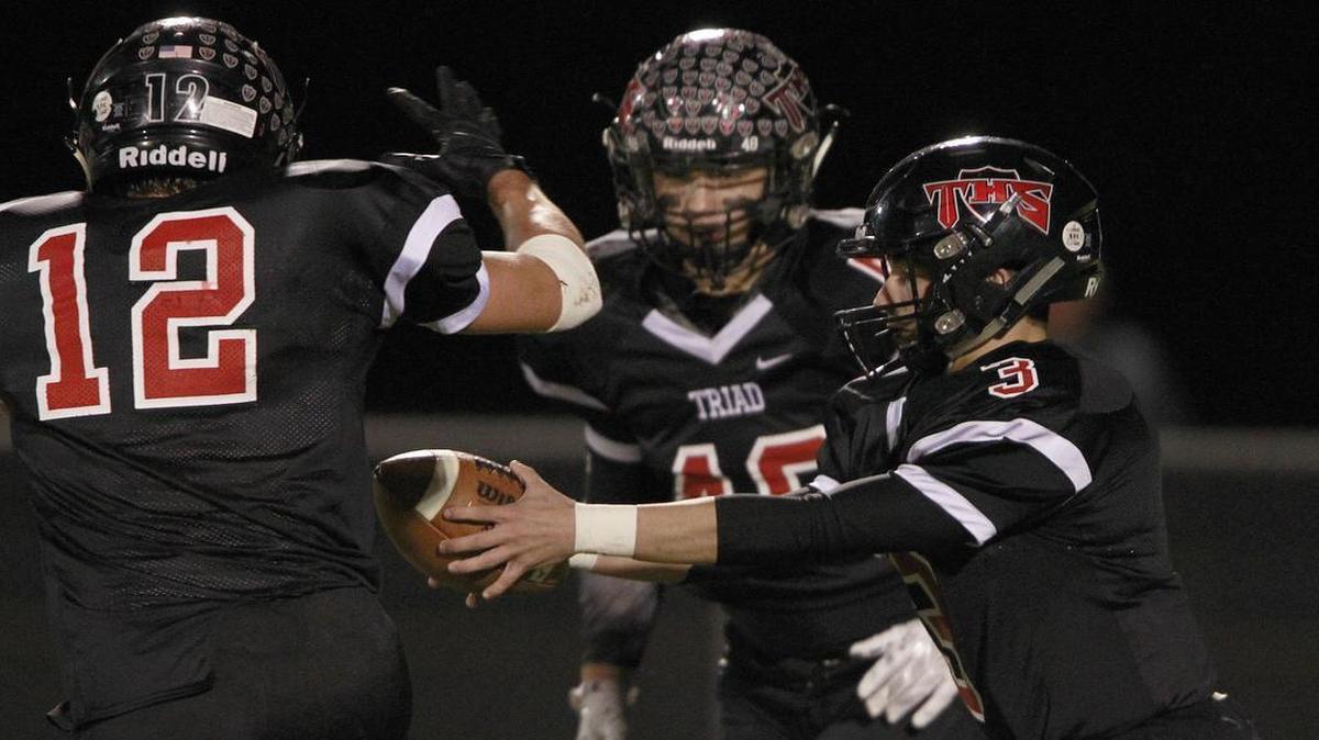 Triad QB Tommy Bauer (3, right) faked a handoff to RB Steven Evanoff (12, left) and gave the ball to Ethan Salopek (48, center) in the first half of the Knights first-round playoff game with Mattoon.