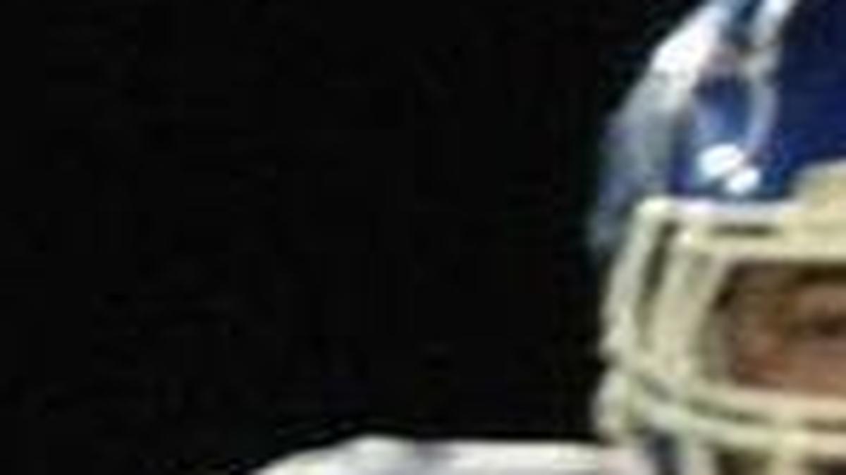 Freeburg senior quarterback Joe Wolf evades tacklers in a game against Columbia. Wolf set five new passing records and tied another during an otherwise disappointing year at Freeburg.