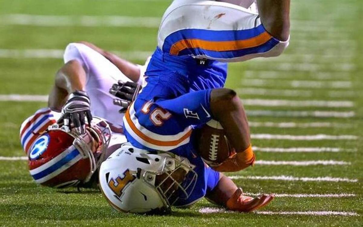 East St. Louis’ DeMonta Whitherspoon is upended by a Shreveport, La. tackler Saturday at the Gateway Scholars Classic. The Flyers’ 14-6 loos to Evangel Christian cost them the top spot in the Illinois AP Class 7A high school football poll.