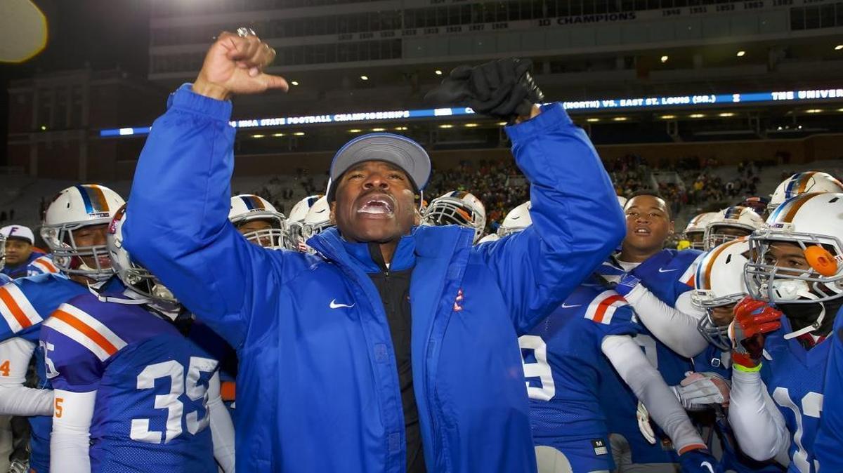 East St. Louis head coach Darren Sunkett as seen celebrating with his team after defeating Plainfield North.