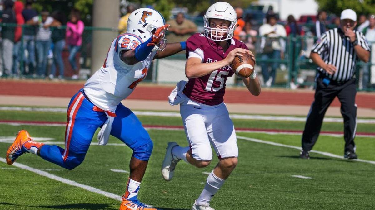 Belleville West’s Jack Mccloskey looks for an open man while being pressure by East St. Louis’ Oliver Mcdowell (23) during a game last year against East St. Louis.