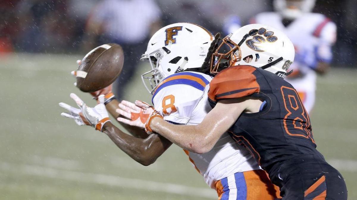 East St. Louis's Markevion Darough intercepts a pass intended for Edwardsville's James Fulton.