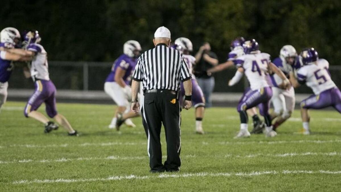 A high school football referee officiates action in Bethalto.