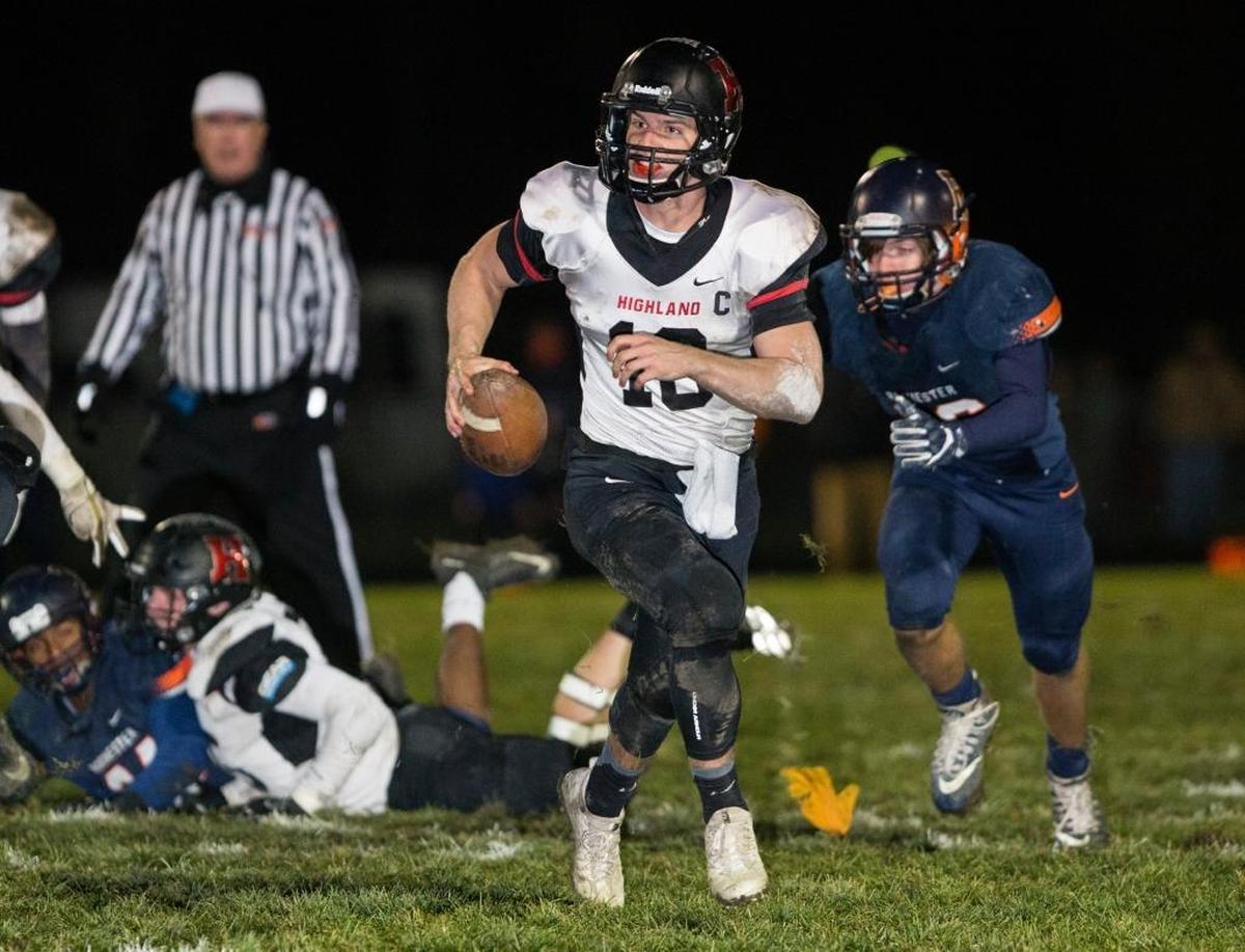 Highland’s Garrett Marti carries the ball Saturday during a playoff game at Rochester High School.