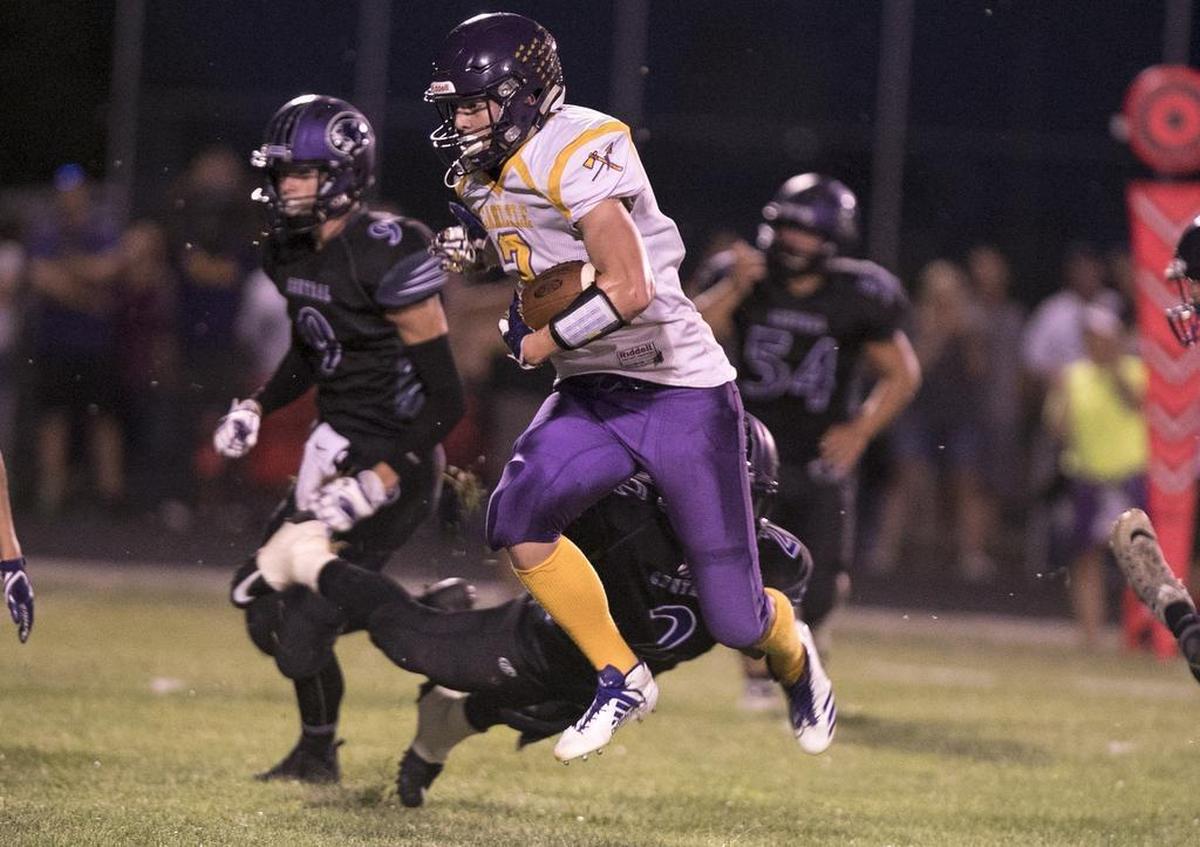 Carlyle Nick Becker leaps to break a tackle on a touchdown run during the first half against Breese Central.