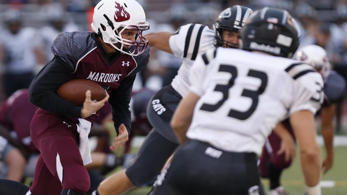 
Normal West defenders close in on Belleville West QB Logan Betz.
