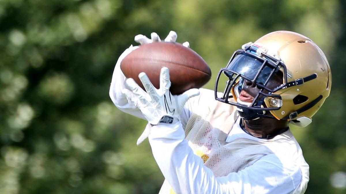 
Althoff High School Football player Keenen Young grabs a catch.
