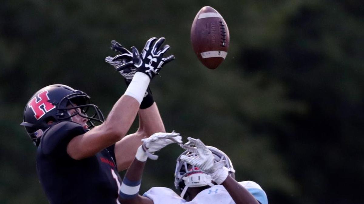 Highland’s Sam LaPorta leaps to make a catch during their game against Belleville East.