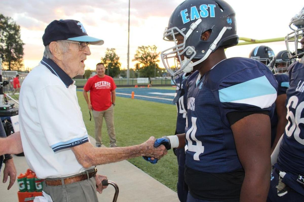 Charlie Woodford, 96, greeted Belleville East players prior to a game in August 2017. Here, he shakes hands with defensive lineman Armonn Anderson. The turf field at East was christened “Charlie Woodford Field” in his honor moments later at the center of the gridiron. Woodford was the founding president of the Belleville East Booster Club and a two-time recipient of the Purple Heart during World War II. He died Sunday.
