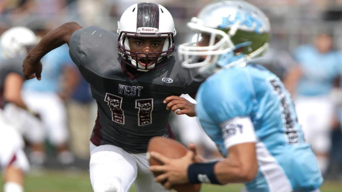 Belleville West’s DeMarlo Nesbitt (left) chased Belleville East quarterback Drew Millas this season, but both are now chasing state playoff victories.