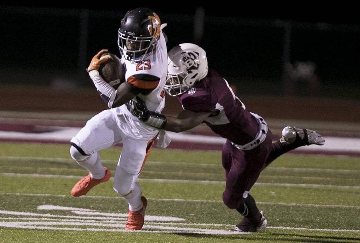 Belleville West’s Kriston Davis puts the wraps on Edwardsville’s Dionte Rodgers in a game last fall.