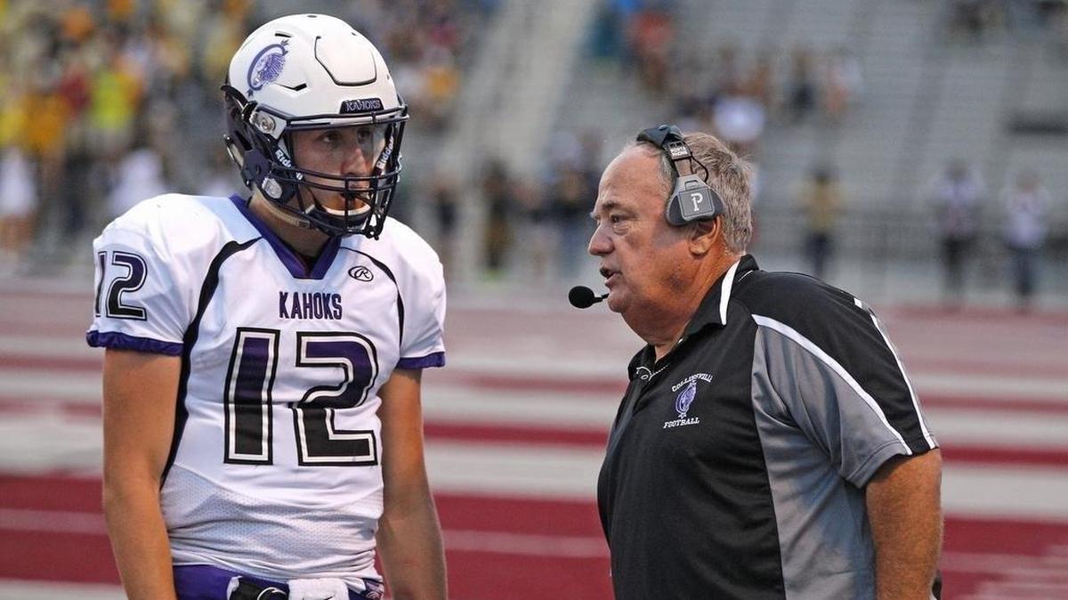 Former Collinsville head coach Rick Reinhart talks to quarterback Jordan Reichert during a game in 2015.