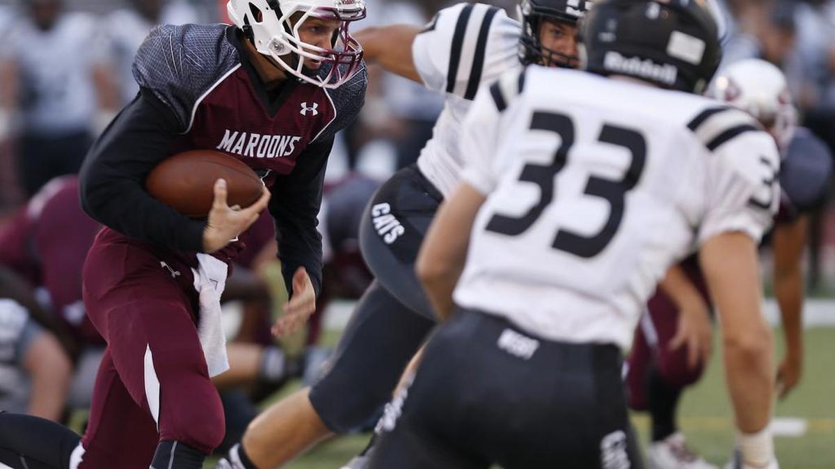 
Normal West defenders close in on Belleville West QB Logan Betz.
