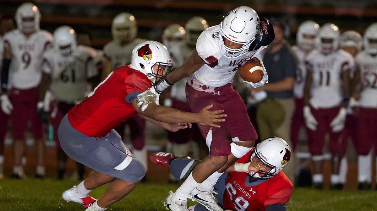 Belleville West Jamarquis Goldsby goes up against Alton defense during Friday’s game.
