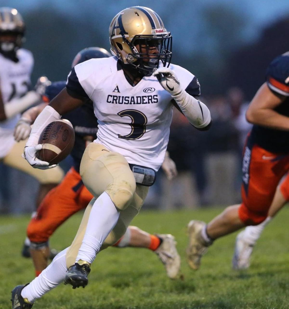 Althoff’s Richard Cosey carries the ball during a second-round playoff game against Rochester at Rochester High School.