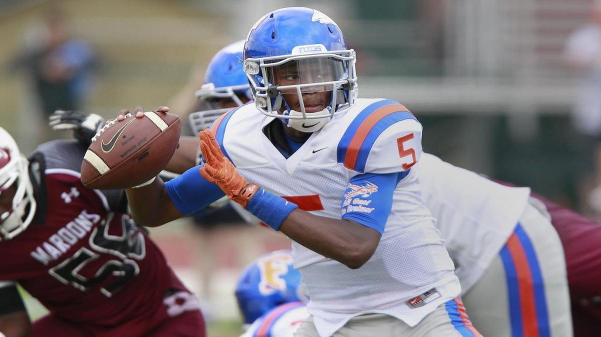 
East St. Louis QB Reyondus Estes (5) looks downfield for a receiver during a Sept. 26 game. District 189 remains on strike and the Flyers (3-4) have already endured two forfeit losses because of the labor situation. One more loss and they will miss the playoffs.
