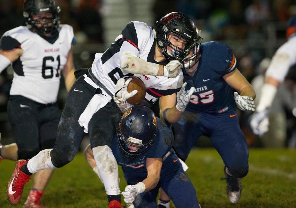 Highland’s Brady Feldmann carries the ball Saturday during a playoff game at Rochester High School.