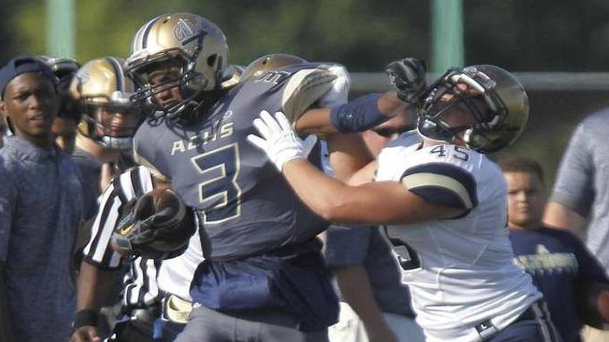 Althoff receiver Edwyn Brown tries to hold off a defender Saturday in the Crusaders’ 51-20 victory over Jefferson City (Mo.) Helias.