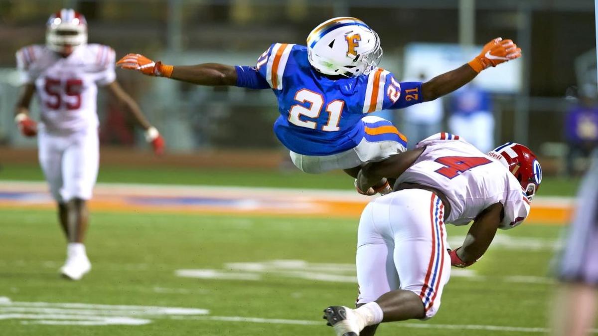East St. Louis’ DeMonta Witherspoon goes air born during Saturday’s game.