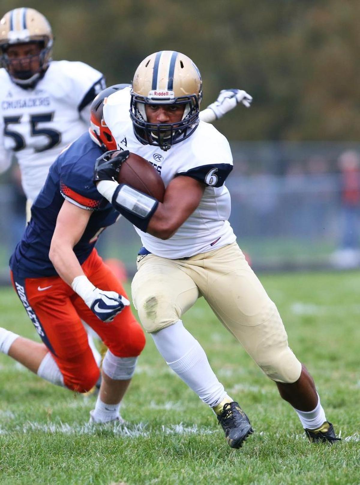 Althoff’s Justin Strong carries the ball during a second-round playoff game against Rochester at Rochester High School.