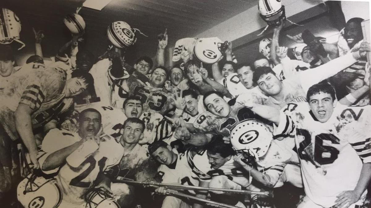 The Lancers celebrate their victory over Belleville West in 1994, the 25th meeting of the cross-town rivals.