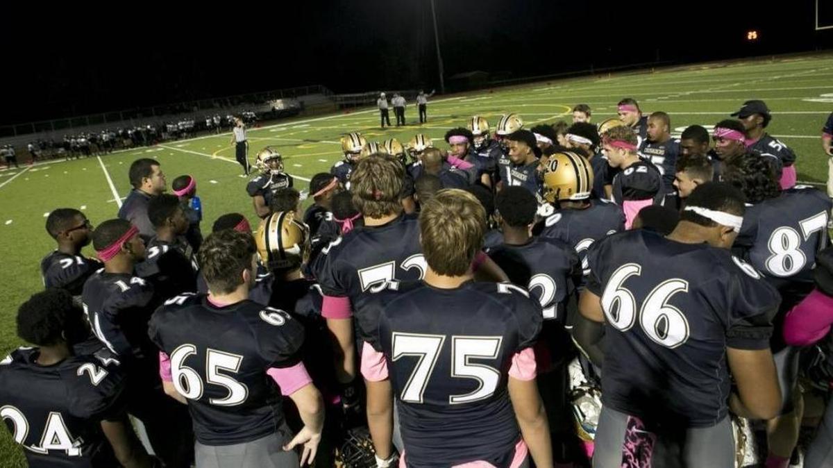 Althoff football players prepare to take the field against Centralia on Sept. 22.