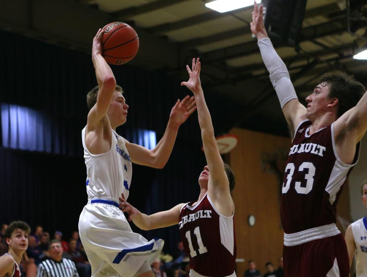 Gibault’s Karson Huels and Trevor Davis move to block Marquette’s Sammy Green during their Class 2A Regional on Friday.