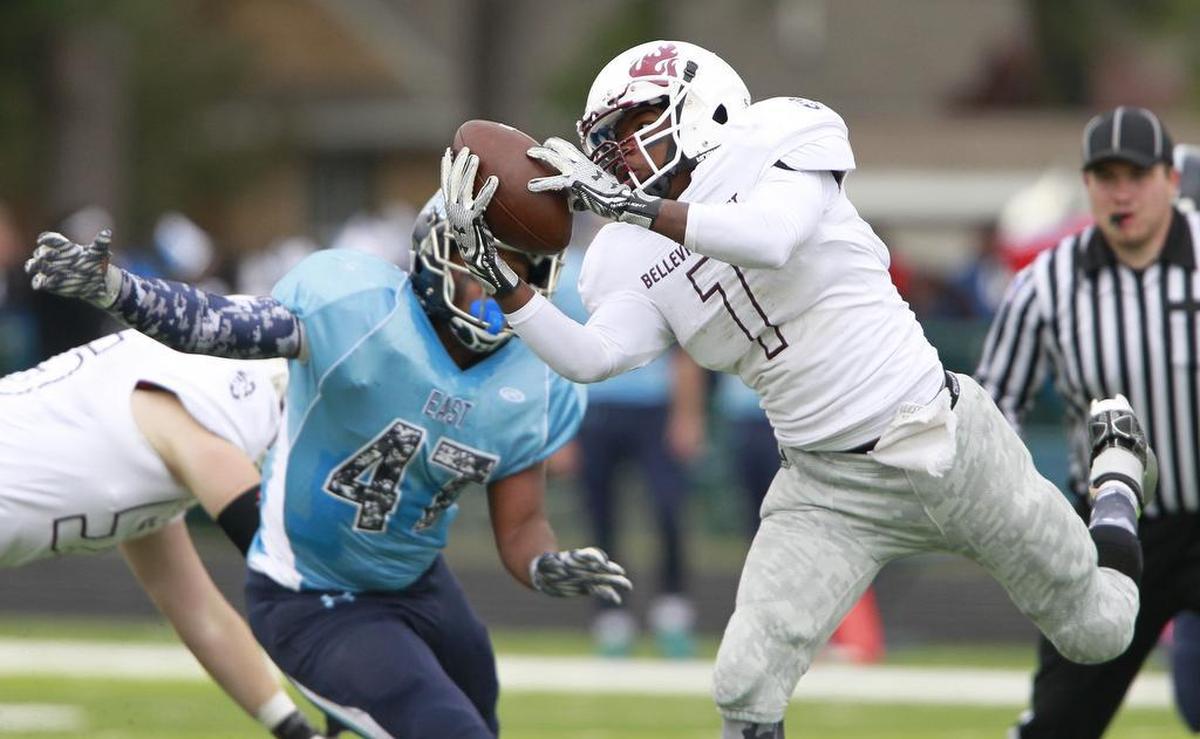 Sherand Boyd Jr, in white, pulls down a pass during his playing days at Belleville West in 2015.