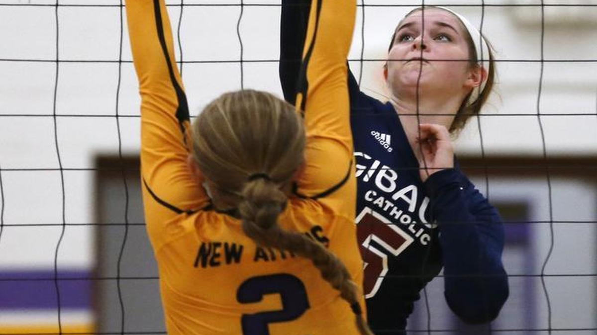 New Athens’Taylor Junge jumps to block Gibault’s Lauren Goldschmidt during their game earlier this season. Goldschmidt repeats as the News-Democrat Volleyball Player of the Year for small schools.