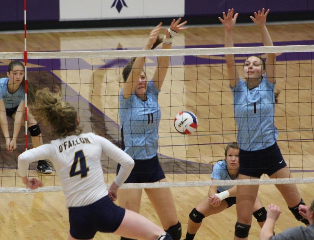 O’Fallon’s Elise Smith, no. 4, hits through an attempted block by Belleville East’s Rachel Mitts and Kelli Determan.