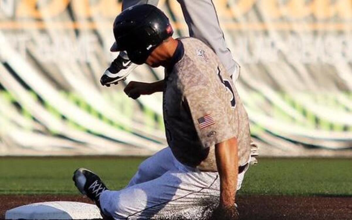 The Grizzlies Anthony Caronia steals second base as the Beach Bums Steve Patterson jumps high to catch the ball .
