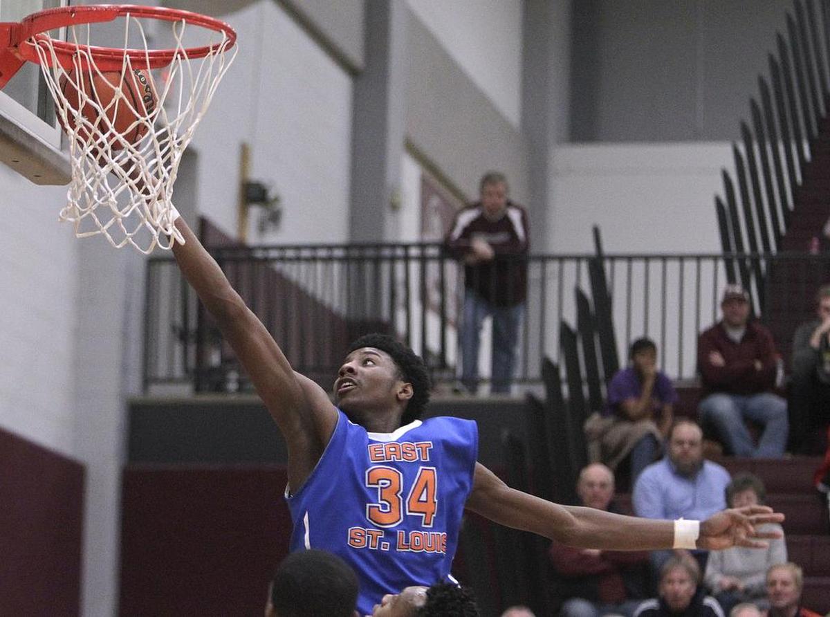 East St. Louis player Terrence Hargrove takes the ball into the basket in a 2018 game.